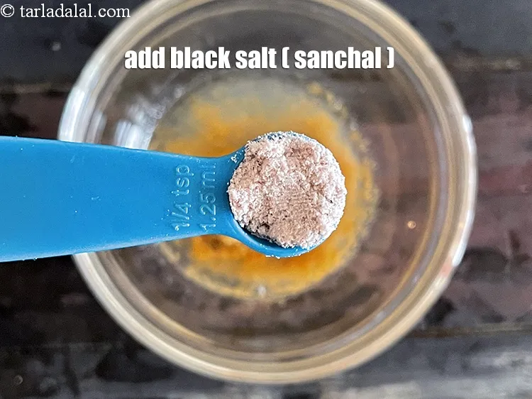 Step 39 – Add&nbsp;<meta charset="UTF-8" />1/4 tsp&nbsp;<a href="glossary-black-salt-sanchal-kala-namak-422i">black salt (sanchal)</a>. <u><em>Sanchal enhances the flavour of the salad.</em></u>