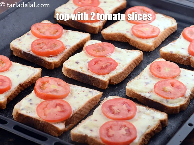 Step 14 – Top it with 2 <a href="https://www.tarladalal.com/glossary-tomato-slices-1823i">tomato slices</a>.&nbsp;