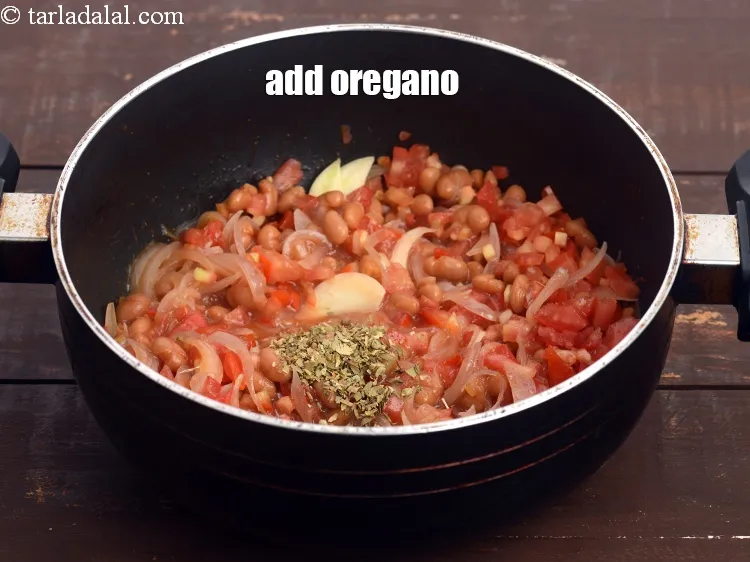 Step 14 – Add 1 tsp&nbsp;<a href="https://tarladalal.com/glossary-dried-oregano-268i">dried oregano</a>.&nbsp;