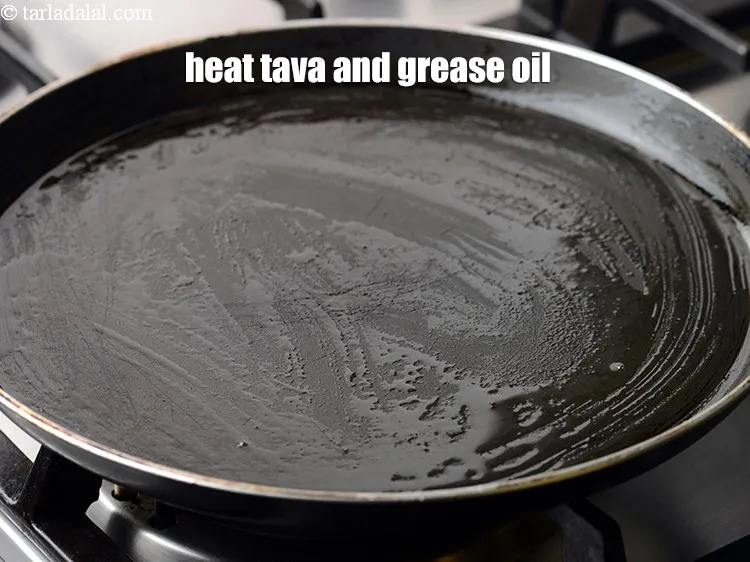 Step 13 – Heat a non-stick tava (griddle) and grease it using &frac12; tsp of oil.