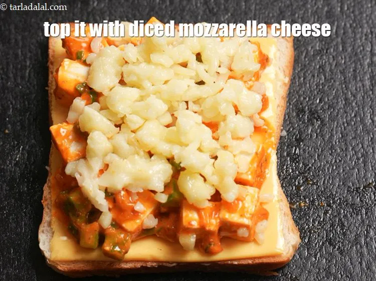 Step 14 – Top it up with &frac14; cup <a href="https://www.tarladalal.com/glossary-diced-mozzarella-cheese-2805i">diced mozzarella cheese</a>.