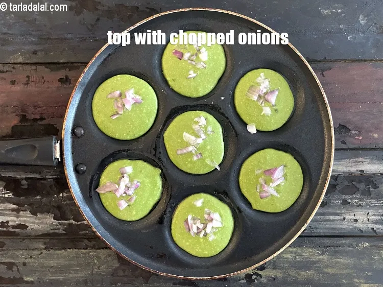 Step 21 – Top all the uttapas of the 1st batch using 2 tbsp of onions.