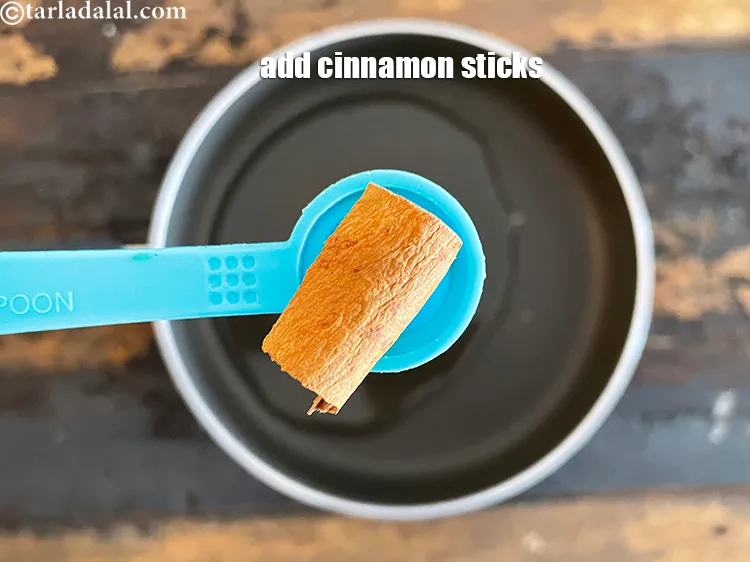 Step 14 – Add&nbsp;2&nbsp;small sticks&nbsp;<a href="https://www.tarladalal.com/glossary-cinnamon-dalchini-346i">cinnamon (dalchini)</a>.