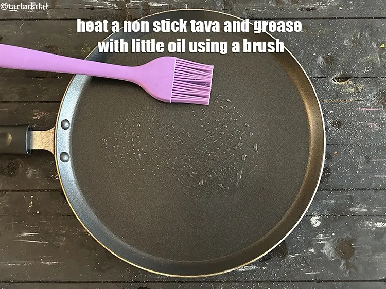 Step 14 – Heat a non stick tava and grease will little oil using a brush.