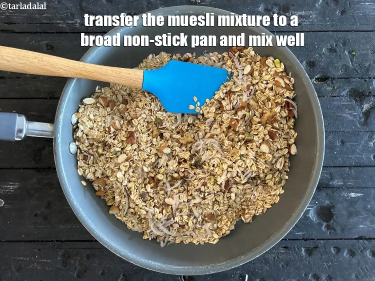 Step 17 – <meta charset="UTF-8" />Transfer the muesli mixture to a&nbsp;broad non-stick pan and mix well.