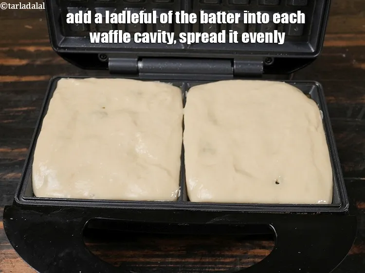 Step 14 – Add a ladleful of the batter into each waffle cavity.&nbsp;Spread it evenly.