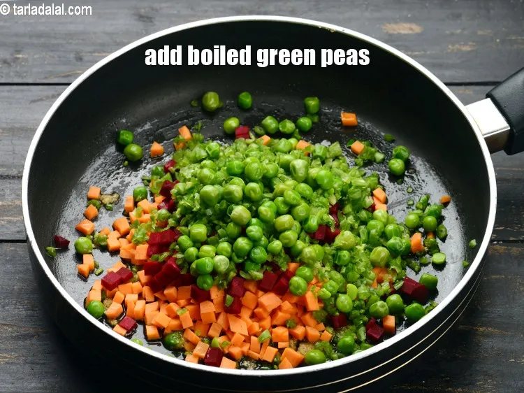 Step 16 – Add &frac14; cup&nbsp;<a href="https://www.tarladalal.com/glossary-boiled-green-peas-1078i">boiled green peas</a>.
