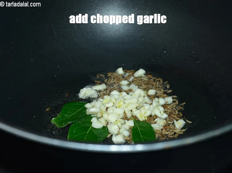 Step 15 – Add 2 tsp <a href="https://www.tarladalal.com/glossary-chopped-garlic-790i">chopped garlic (lehsun)</a>.