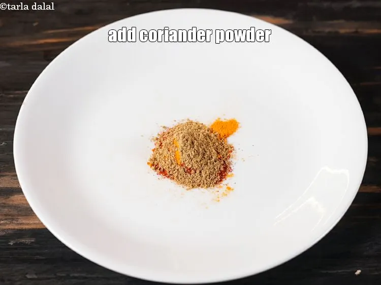 Step 15 – Add &frac12; tsp <a href="https://www.tarladalal.com/glossary-coriander-powder-dhania-powder-370i">coriander (dhania) powder</a>.