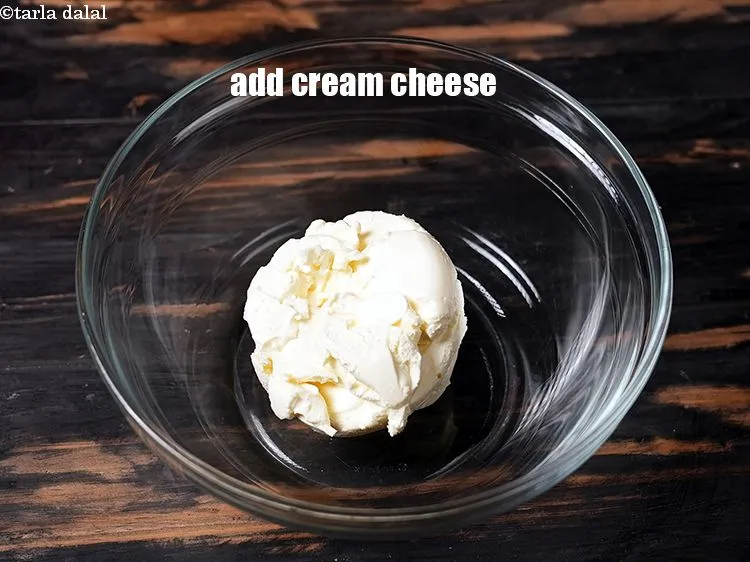 Step 16 – In another deep bowl, add &frac12; cup <a href="https://www.tarladalal.com/glossary-cream-cheese-319i">cream cheese</a>.&nbsp;
