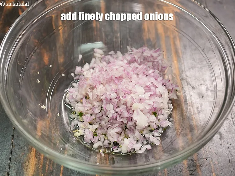 Step 15 – Add &frac12; cup finely <a href="https://www.tarladalal.com/glossary-chopped-onions-722i">chopped onions</a>.