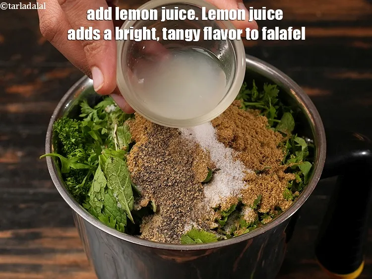 Step 15 – Add 2 tbsp <a href="https://www.tarladalal.com/glossary-lemon-juice-numbi-ka-ras-nimbu-ka-juice-471i">lemon juice</a>. Lemon juice adds a bright, tangy flavor to falafel.