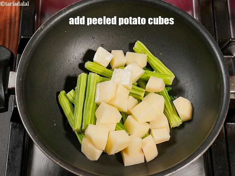Step 15 – Add 1 cup peeled <a href="https://www.tarladalal.com/glossary-potato-cubes-725i">potato cubes</a>.
