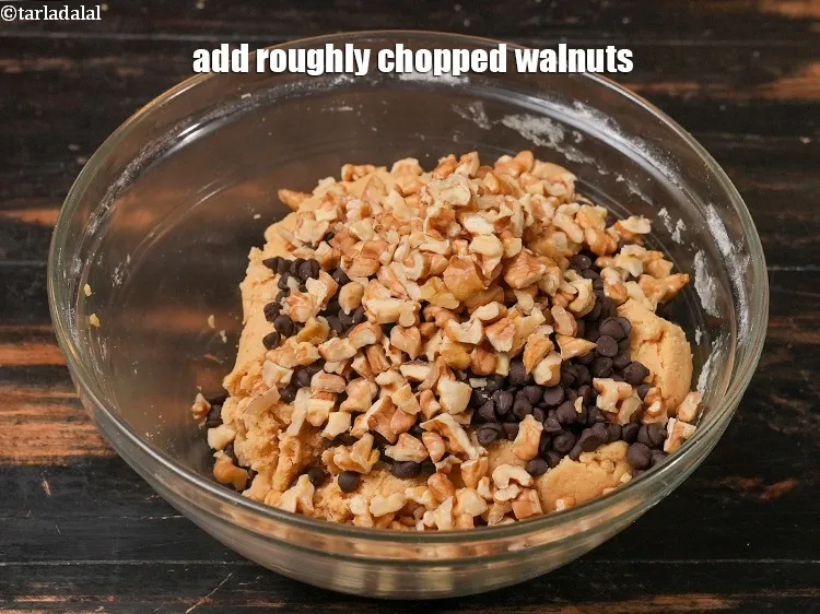 Step 15 – Add &frac12; cup roughly <a href="https://www.tarladalal.com/glossary-chopped-walnuts-785i">chopped walnuts (akhrot)</a>.