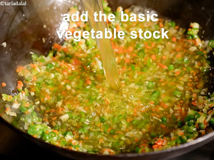 Step 18 – Add the <a href="https://www.tarladalal.com/basic-vegetable-stock-38556r">basic vegetable stock</a>.
