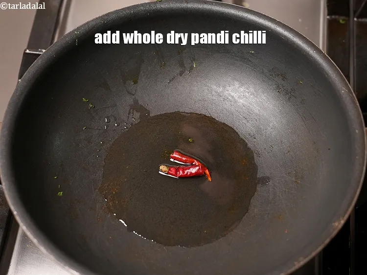 Step 15 – Add 1 whole dry pandi chilli.&nbsp;