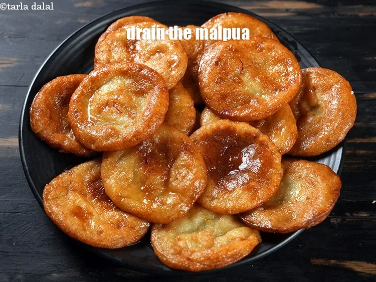 Step 27 – Drain the malpua from the sugar syrup and place it on a serving plate.