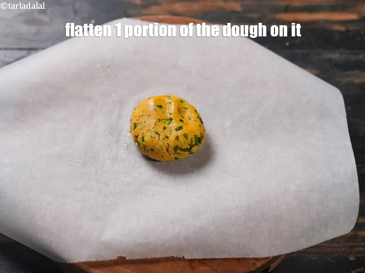 Step 15 – Flatten 1 portion of the dough on it.