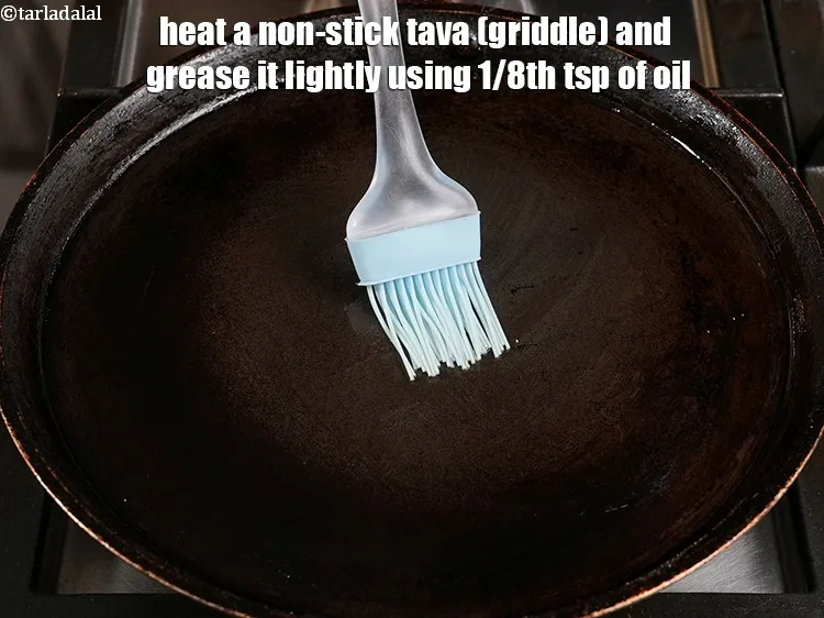 Step 14 – Heat a non-stick tava (griddle) and grease it lightly using 1/8th&nbsp;tsp of oil.
