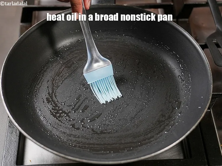 Step 15 – Heat &frac12; tsp <a href="https://www.tarladalal.com/glossary-oil-671i">oil</a> in a broad nonstick pan.
