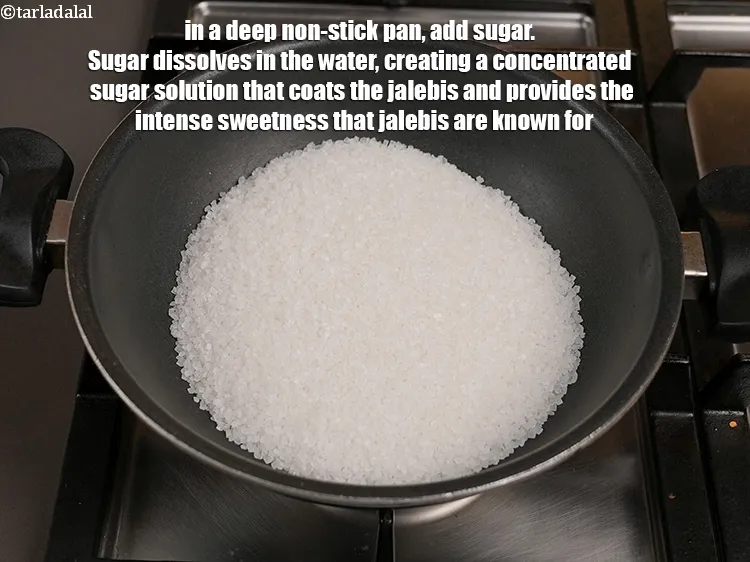 Step 15 – In a deep non-stick pan, add 2 cups of <a href="https://tarladalal.com/glossary-sugar-chini-shakkar-278i">sugar</a>.&nbsp;Sugar dissolves in the water, …