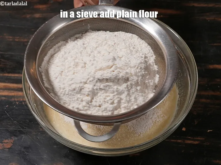 Step 15 – In a sieve add 1&frac14; cups of <a href="https://www.tarladalal.com/glossary-plain-flour-maida-188i">plain flour (maida)</a>.