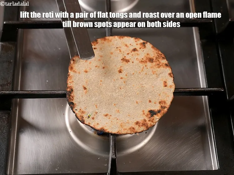 Step 15 – Lift the roti with a pair of flat tongs and roast over an open flame …