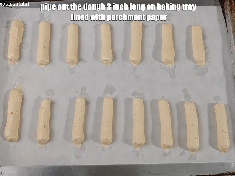 Step 15 – Pipe out the dough 3 inch long on baking tray lined with parchment paper.