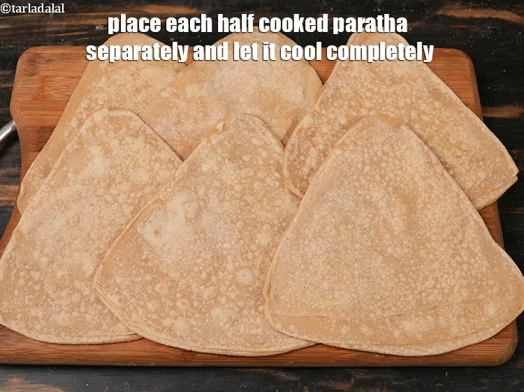 Step 18 – Place each half cooked paratha separately and let it cool completely.