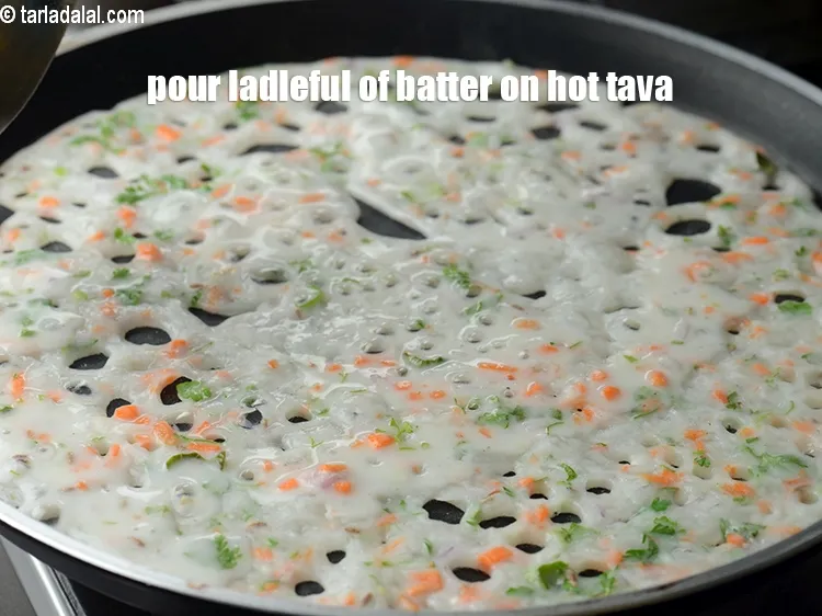 Step 17 – Pour a ladleful of the batter on hot tava to make a dosa.