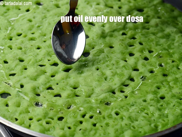 Step 15 – Put 1 tsp oil evenly over the dosa.&nbsp;
