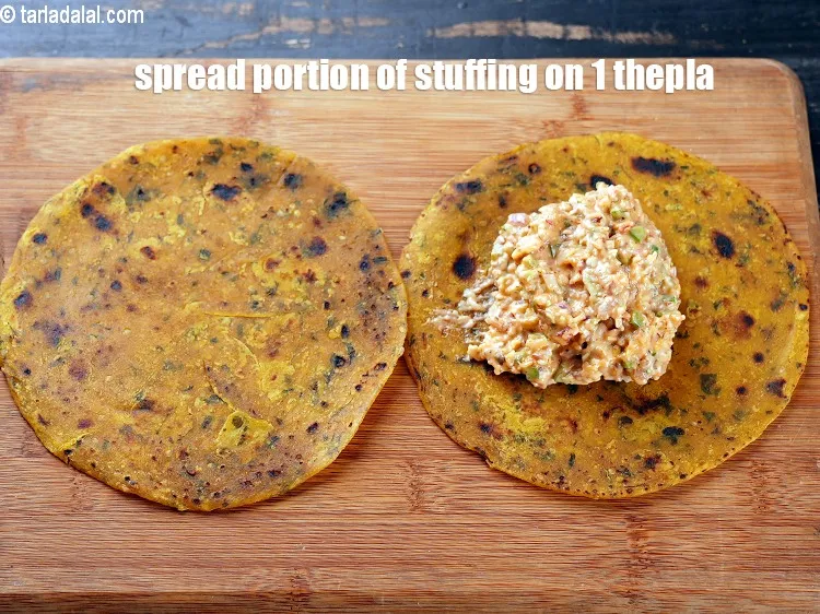 Step 15 – Spread a portion of the stuffing on 1 thepla.&nbsp;