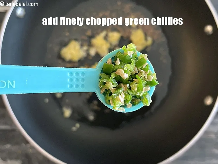 Step 26 – Add&nbsp;<meta charset="UTF-8" />1/2 tsp&nbsp;finely&nbsp;<a href="glossary-chopped-green-chilli-820i">chopped green chillies</a>.