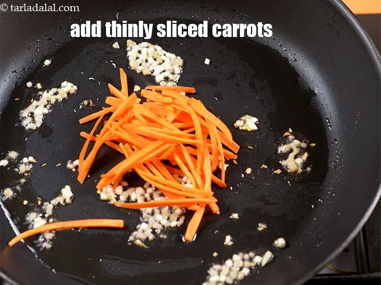Step 16 – Add &frac12; cup thinly&nbsp;<a href="https://www.tarladalal.com/glossary-sliced-carrots-748i">sliced carrot</a>.