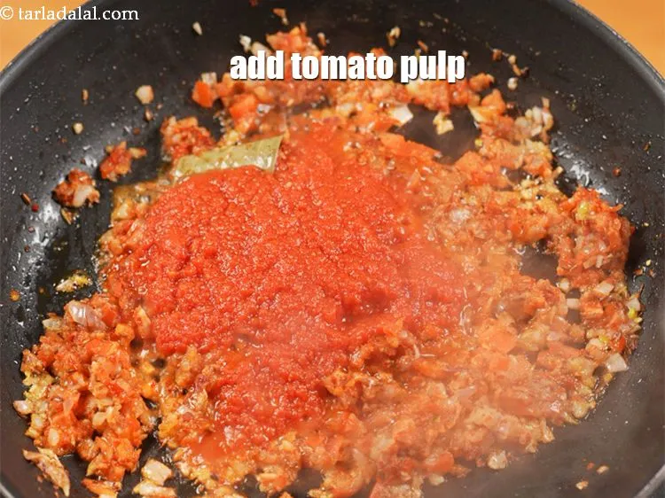 Step 15 – Add &frac12; cup <a href="https://www.tarladalal.com/glossary-tomato-pulp-tamatar-ka-pulp-1039i">tomato pulp</a>.