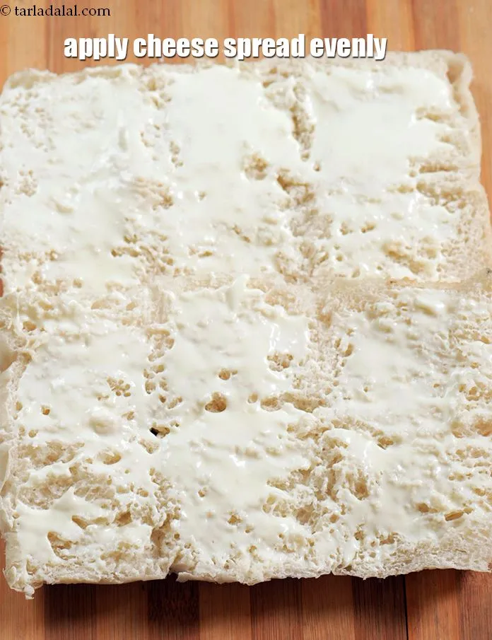 Step 16 – Apply &frac14; cup <a href="https://www.tarladalal.com/glossary-cheese-spread-309i">cheese spread</a> evenly over it.&nbsp;
