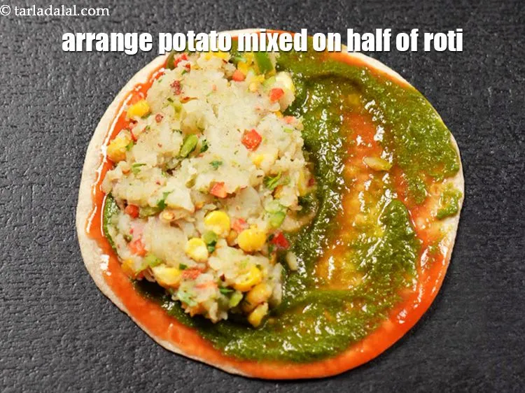 Step 15 – Arrange &amp;frac14; cup of potato mixed on half of the roti.