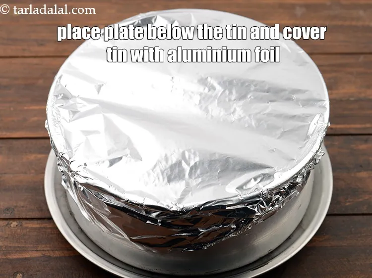 Step 15 – Place a plate below the tin and cover the tin with aluminium foil.&nbsp;