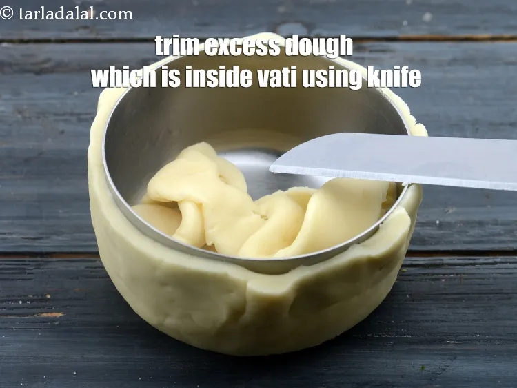Step 16 – Trim the excess dough which is inside the vati using a knife.