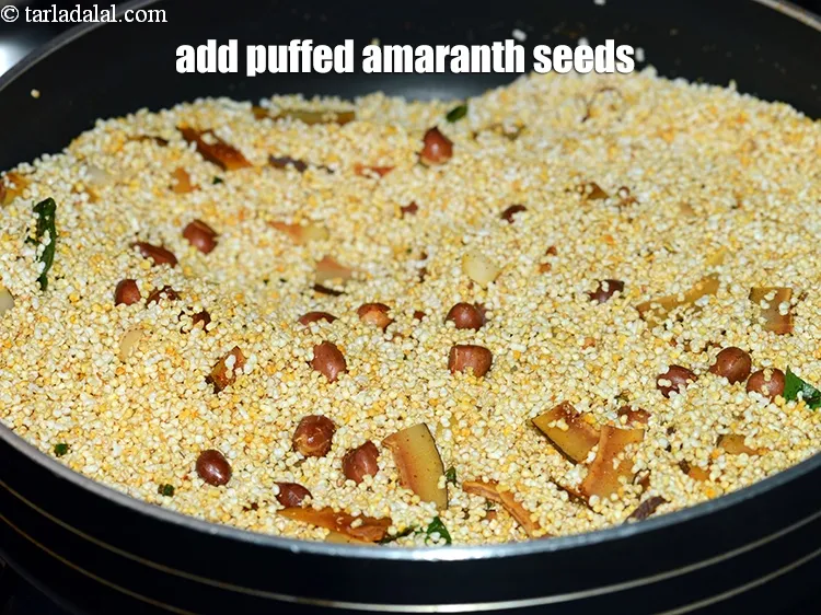 Step 15 – Add 4 cups <a href="https://www.tarladalal.com/glossary-puffed-amaranth-seeds-puffed-rajgira-rajgira-seeds-2707i">puffed amaranth (rajgira) seeds</a>.&nbsp;