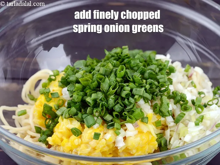 Step 16 – Add &frac14; cup finely <a href="https://www.tarladalal.com/glossary-chopped-spring-onion-greens-1030i">chopped spring onion greens</a>.