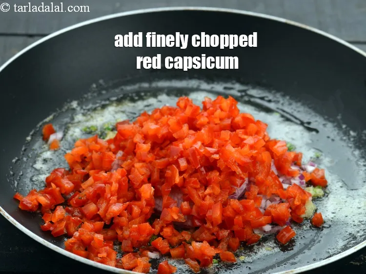 Step 15 – Add 1/2 cup&nbsp;finely&nbsp;<a href="https://www.tarladalal.com/glossary-chopped-red-capsicum-2299i">chopped red capsicum</a>.