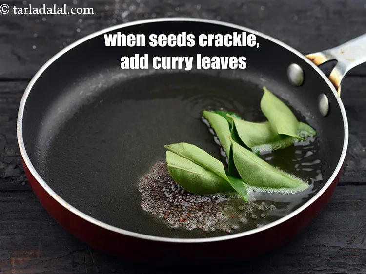 Step 15 – When the seeds crackle, add 8 to 10&nbsp;<a href="https://www.tarladalal.com/glossary-curry-leaves-kadi-patta-kadipatta-388i">curry leaves (kadi patta)</a>.