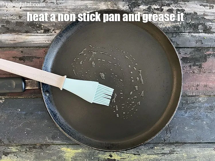 Step 17 – Heat a non-stick tava (griddle) and grease it with oil or ghee.&nbsp;