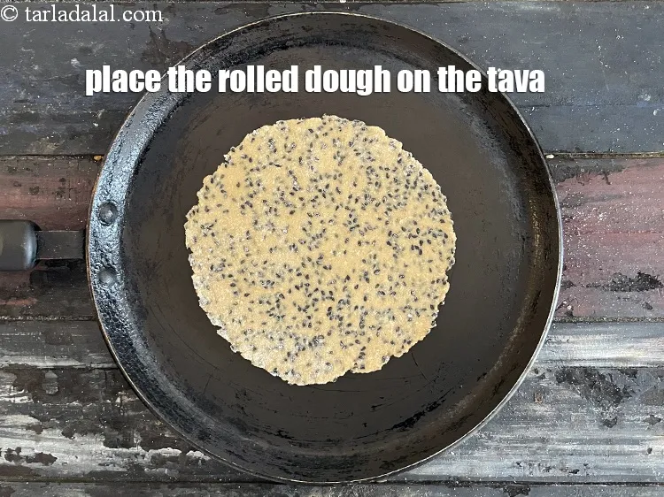Step 14 – Place the rolled dough on the hot tava.