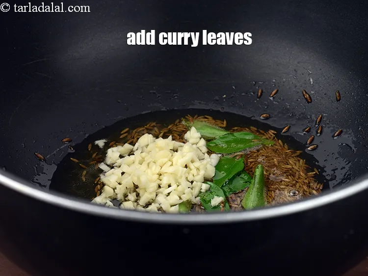 Step 16 – When the seeds crackle, add 1 tbsp finely&nbsp;<a href="https://www.tarladalal.com/glossary-chopped-garlic-790i">chopped garlic (lehsun)</a>.