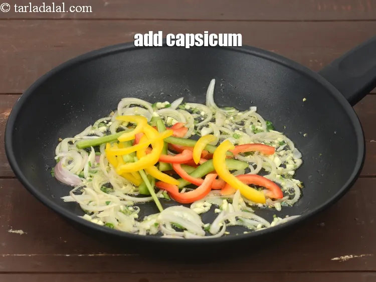Step 15 – Add 1/2 cup&nbsp;thinly&nbsp;<a href="https://www.tarladalal.com/glossary-sliced-coloured-capsicum-2803i">sliced coloured capsicum</a>.&nbsp;