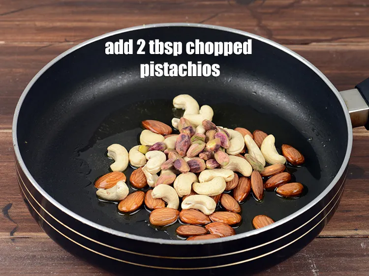 Step 15 – Add 2 tbsp <a href="https://www.tarladalal.com/glossary-chopped-pistachios-893i">chopped pistachios</a>.
