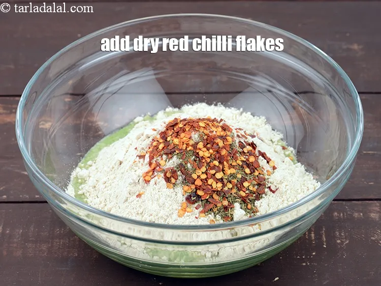 Step 15 – Add 1 tsp <a href="https://www.tarladalal.com/glossary-dry-red-chilli-flakes-paprika-338i">dry red chilli flakes (paprika)</a>.