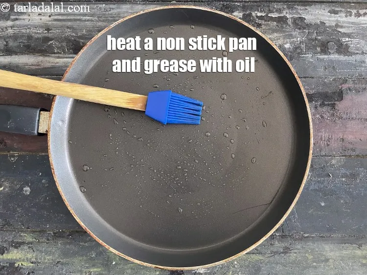 Step 20 – <meta charset="UTF-8" /> Heat a non-stick tava (griddle) and grease with oil.